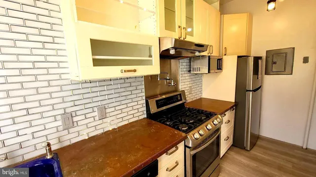 a kitchen with stainless steel appliances a stove and a refrigerator