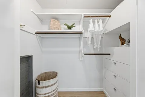 a spacious bedroom with a bed couch and a window