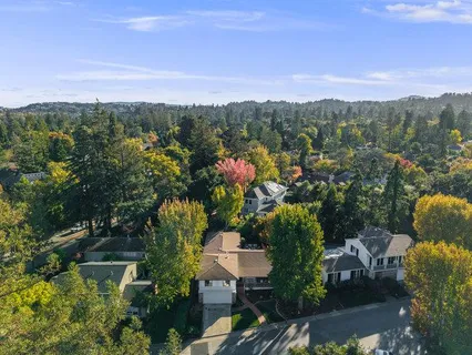 an aerial view of a house with a yard and garden