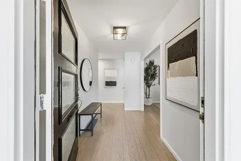 a living room with furniture a fireplace and a large window