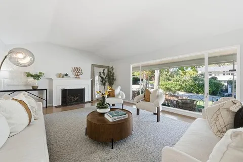a living room with furniture and a floor to ceiling window
