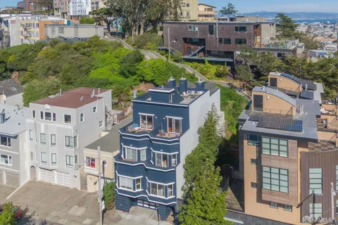 a aerial view of multiple houses with a yard