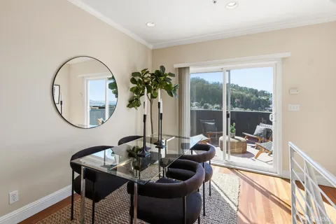 a kitchen with stainless steel appliances granite countertop a stove a sink dishwasher a refrigerator and a microwave oven with wooden floor