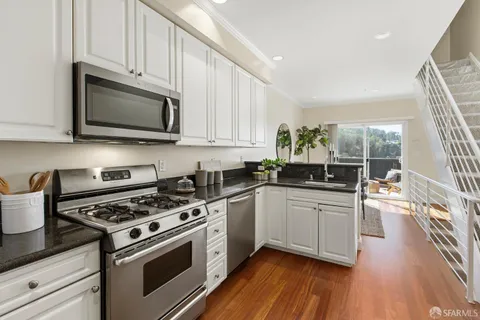 a living room with furniture a window and a potted plant