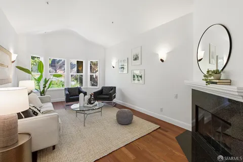 a spacious bedroom with a bed and painting on the wall