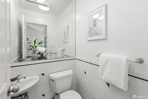 a bedroom with a large bed and a potted plant