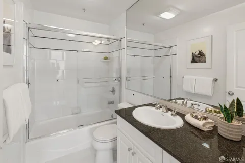 a bedroom with a bed and a potted plant