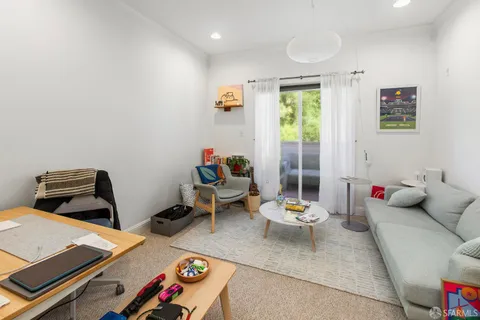 a dining room with furniture and a window