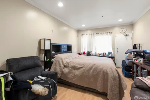 a kitchen with a stove a sink dishwasher and a refrigerator with wooden floor