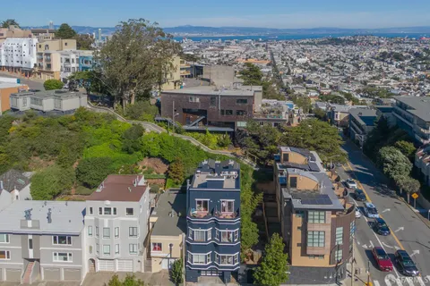 an aerial view of a house with a yard