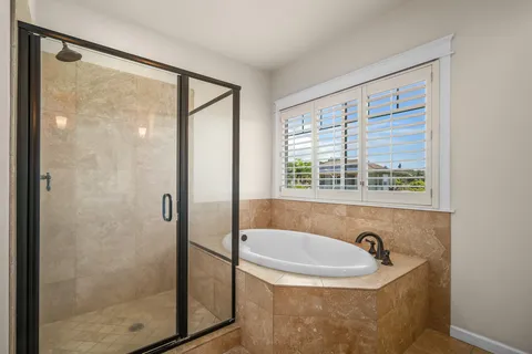 a bathroom with a sink a shower and a window