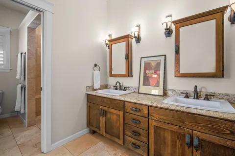 a bathroom with a double vanity sink and a mirror