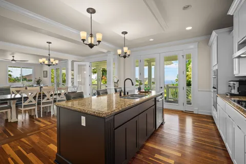 a kitchen with center island table and chairs