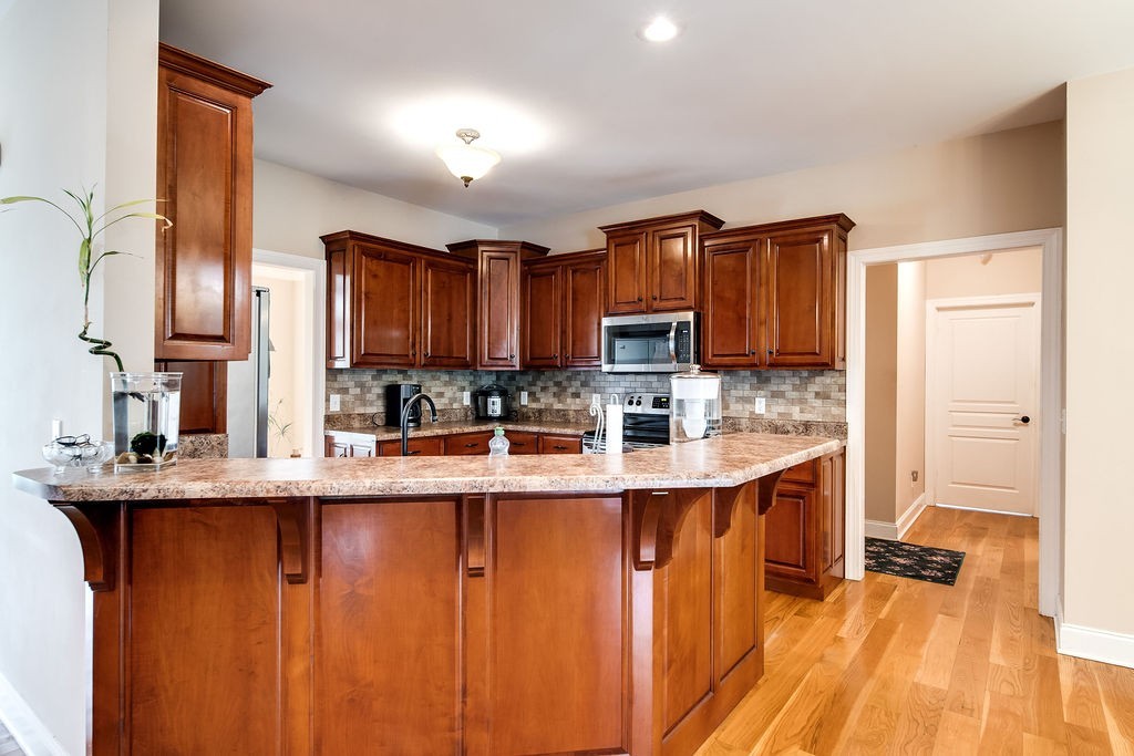 181 Dry Fork Road South Bethpage, TN 37022 - Photo 20 of 52 a kitchen with stainless steel appliances granite countertop a sink refrigerator and cabinets