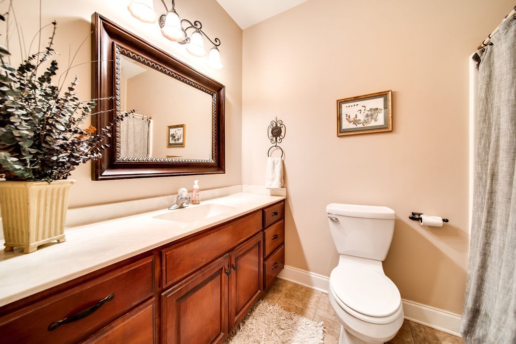 181 Dry Fork Road South Bethpage, TN 37022 - Photo 23 of 52 a bathroom with a toilet a sink and mirror