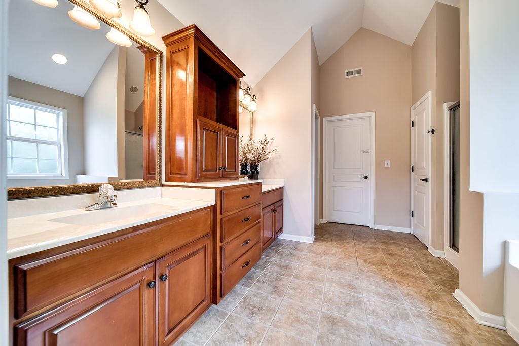 181 Dry Fork Road South Bethpage, TN 37022 - Photo 26 of 52 a spacious bathroom with a double vanity sink a mirror and a shower
