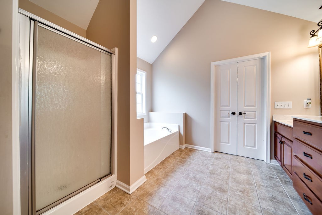 181 Dry Fork Road South Bethpage, TN 37022 - Photo 31 of 52 a bathroom with a tub shower sink and mirror