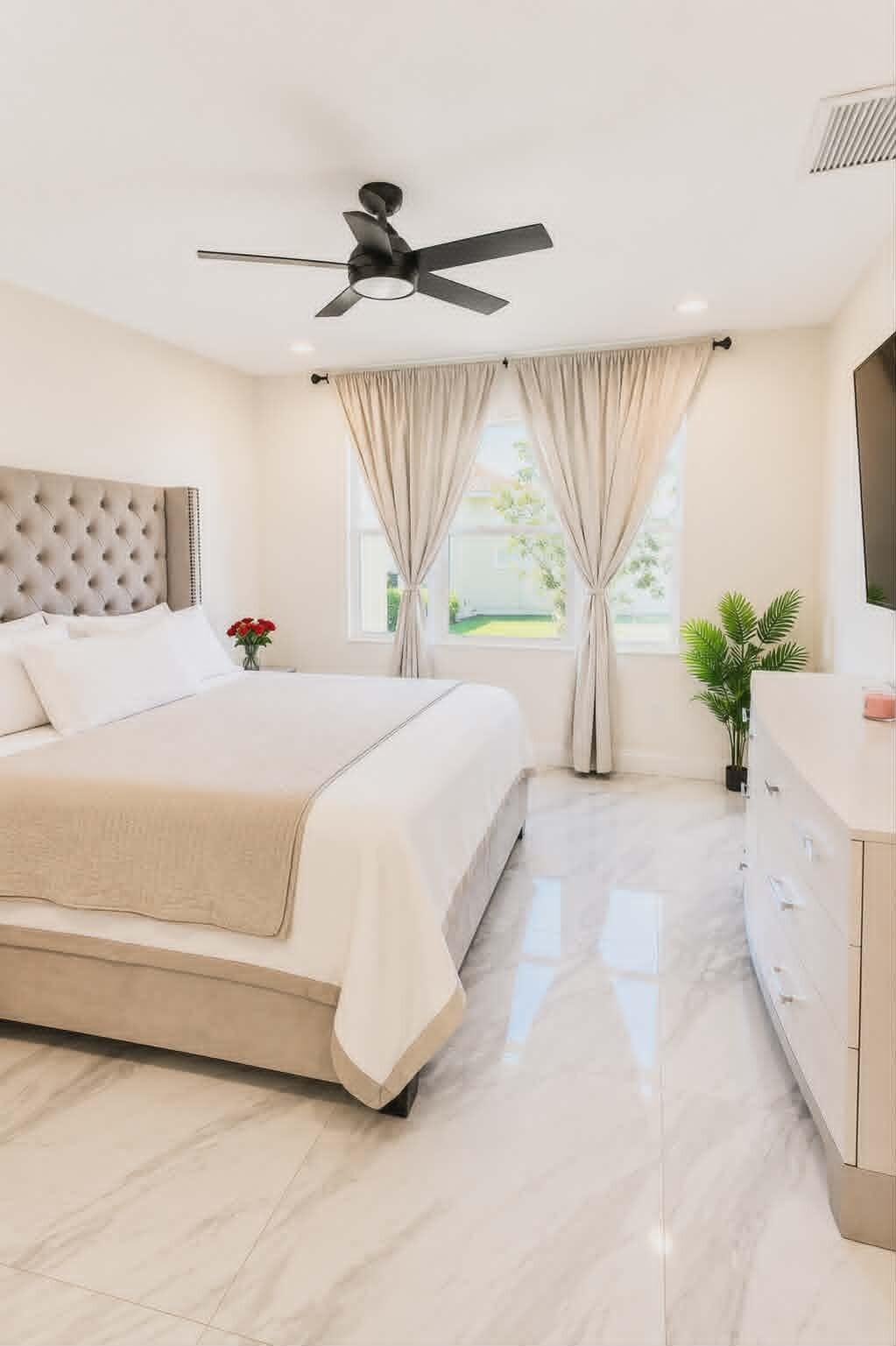 19179 Rolling Acrs Road Loxahatchee, FL 33470 - Photo 25 of 38 a spacious bedroom with a bed and a potted plant
