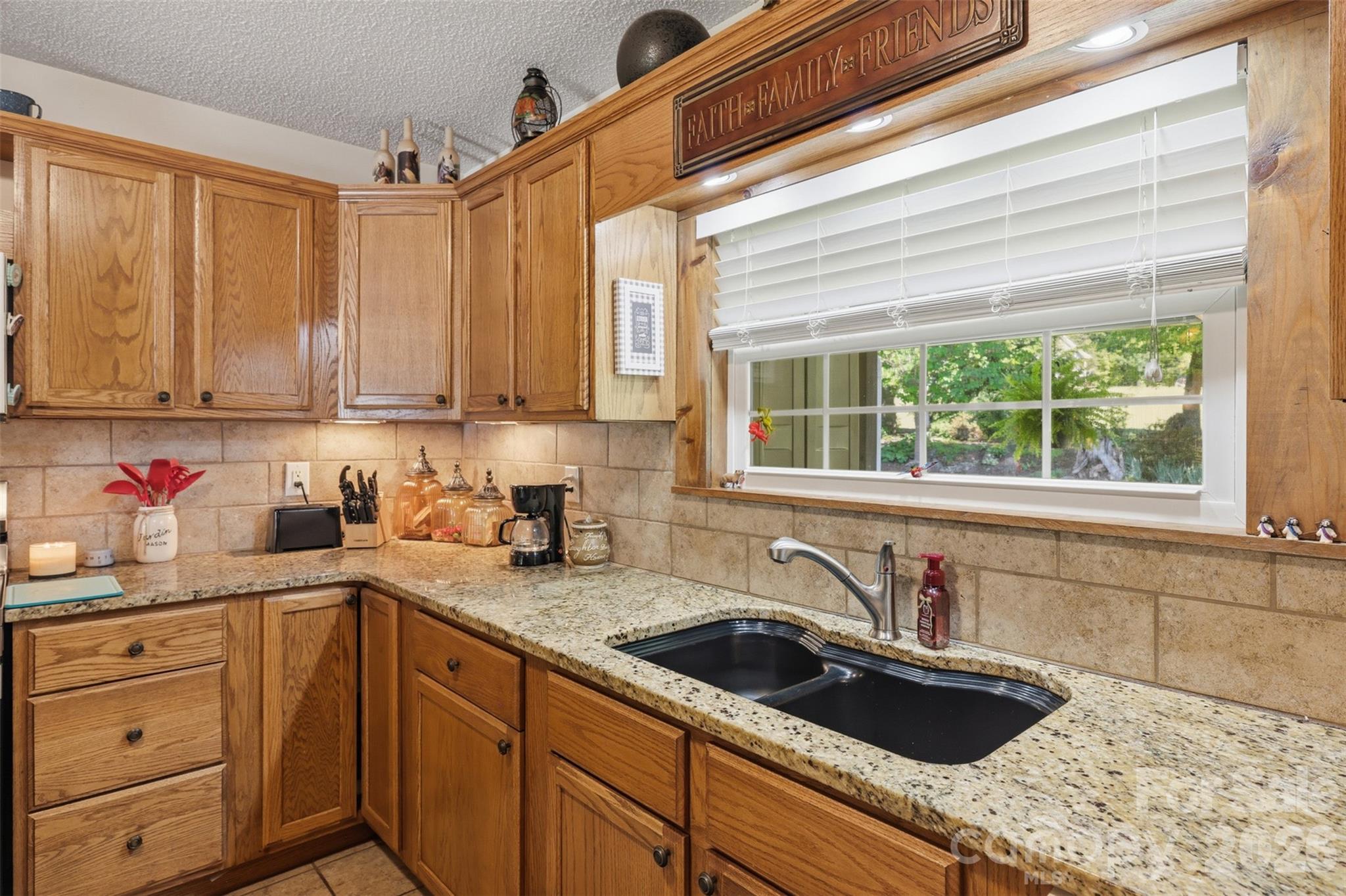 176-174 Oak Hollow Road Union Grove, NC 28689 - Photo 24 of 48 a kitchen with sink cabinets and window