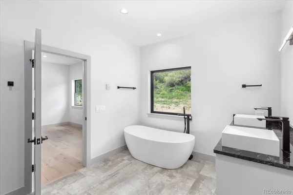 a bathroom with a granite countertop toilet and sink