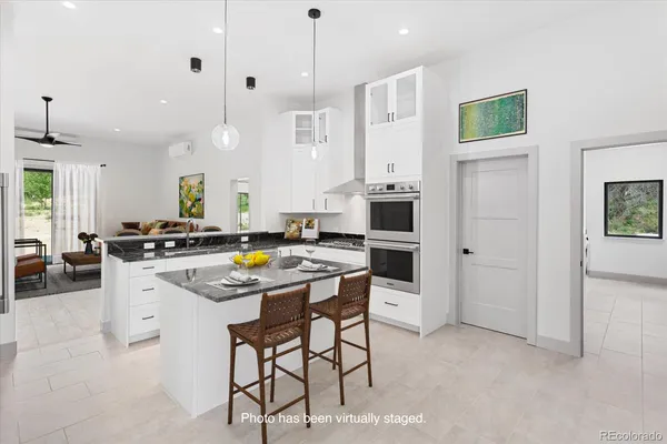 a view of a livingroom with a furniture wooden floor and a ceiling fan