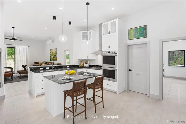 a view of a livingroom with a furniture wooden floor and a ceiling fan