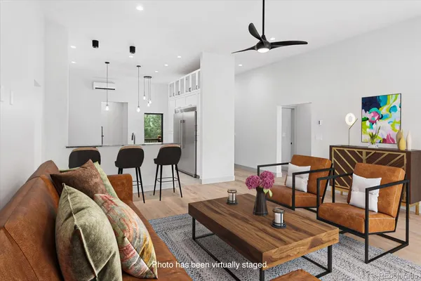 a large kitchen with granite countertop a stove a sink dishwasher and a refrigerator with wooden floor