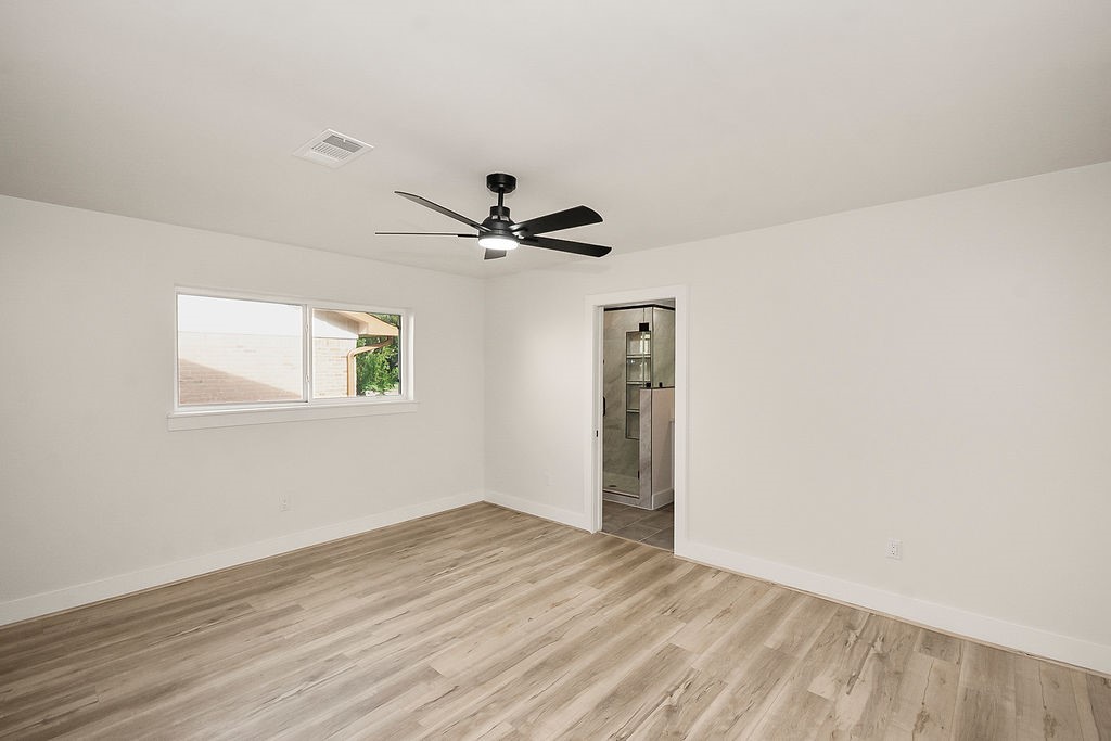 6106 Rutherglenn Drive Houston, TX 77096 - Photo 22 of 41 Bright secondary bedroom with updated flooring and modern ceiling fan.
