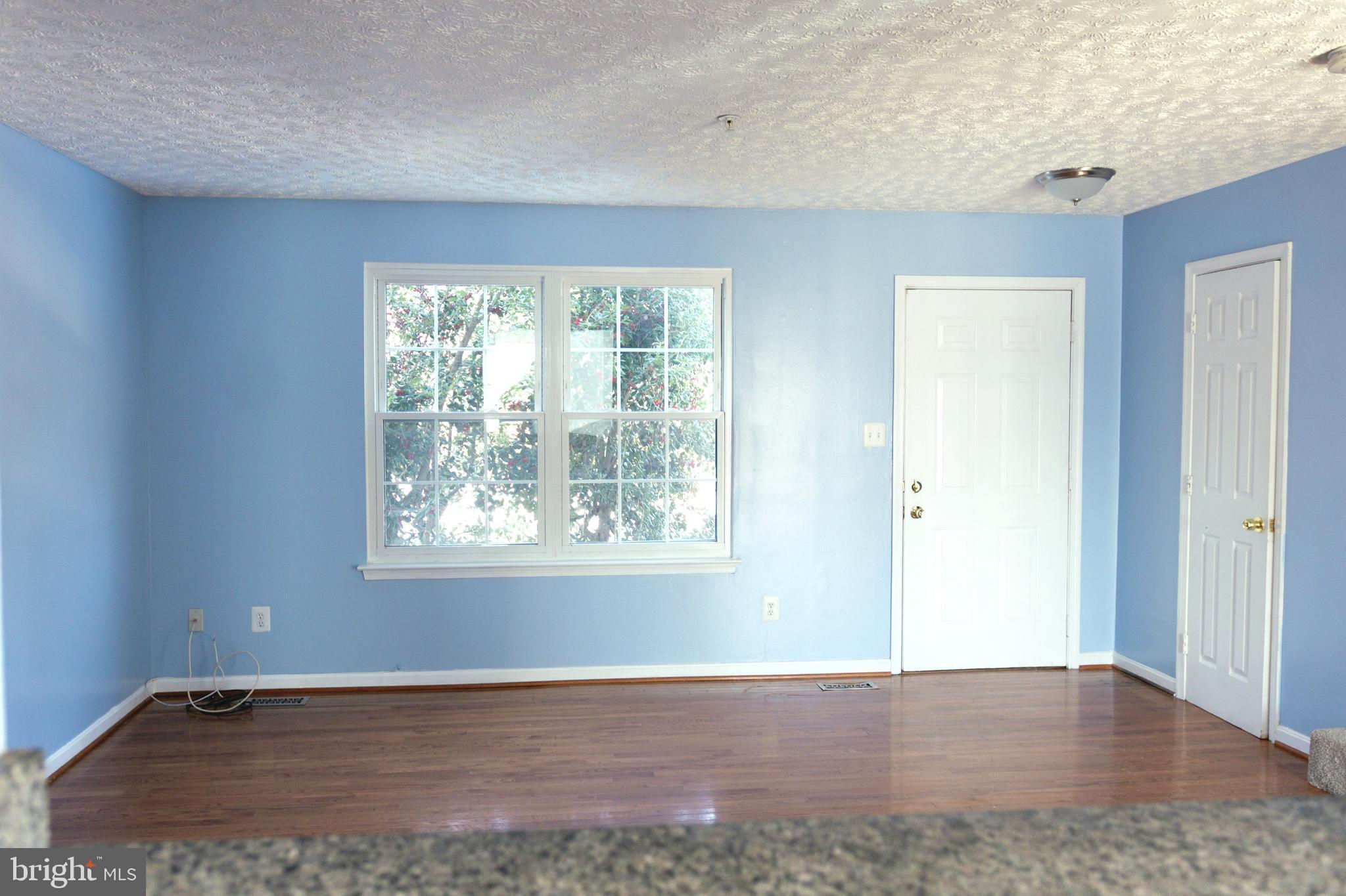 2323 Bluegrass Heights Court Rosedale, MD 21237 - Photo 3 of 14 an empty room with wooden floor and windows