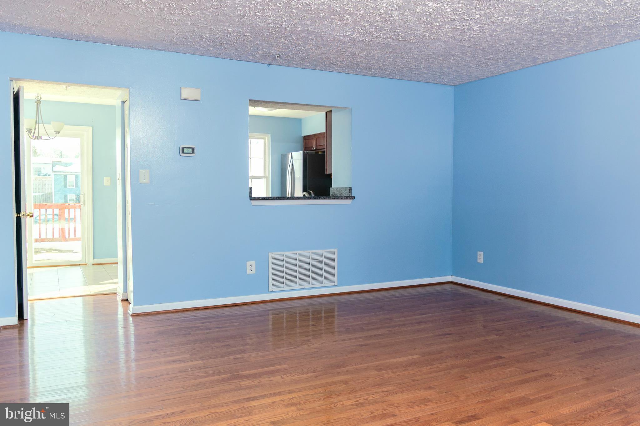 2323 Bluegrass Heights Court Rosedale, MD 21237 - Photo 6 of 14 a view of an empty room with wooden floor and a window