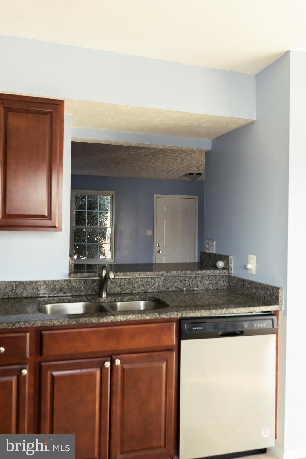 2323 Bluegrass Heights Court Rosedale, MD 21237 - Photo 7 of 14 a kitchen with granite countertop a sink and cabinets