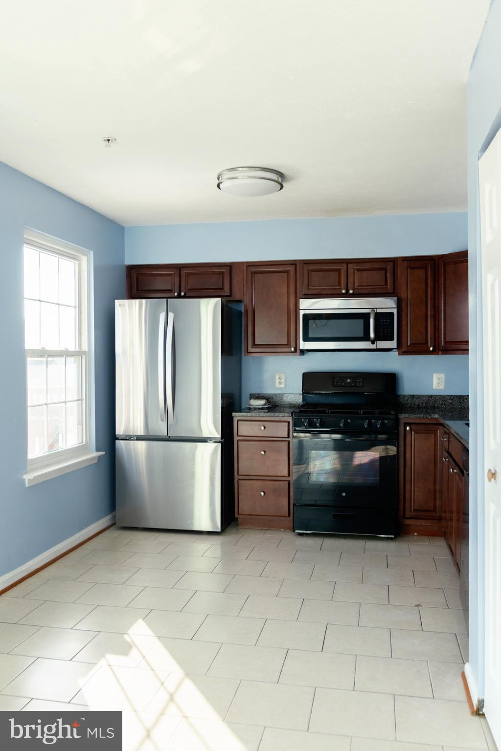 2323 Bluegrass Heights Court Rosedale, MD 21237 - Photo 10 of 14 a kitchen with a refrigerator sink and stove top oven