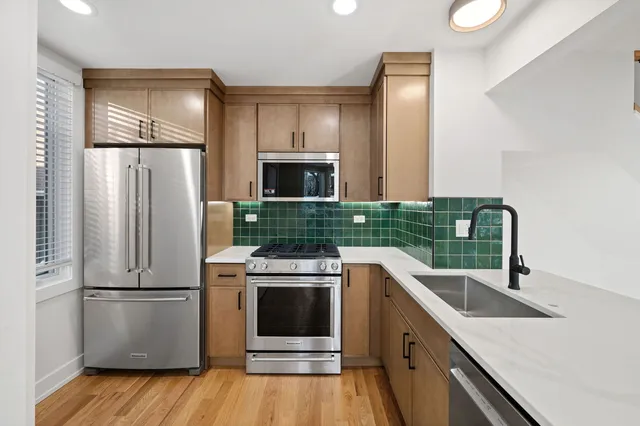 a kitchen with a refrigerator sink and stove