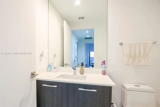 a view of a bathroom from the hallway