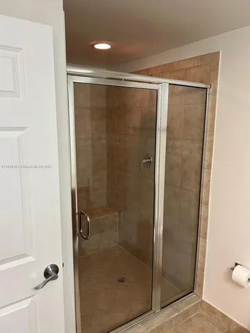 a bathroom with a glass shower door