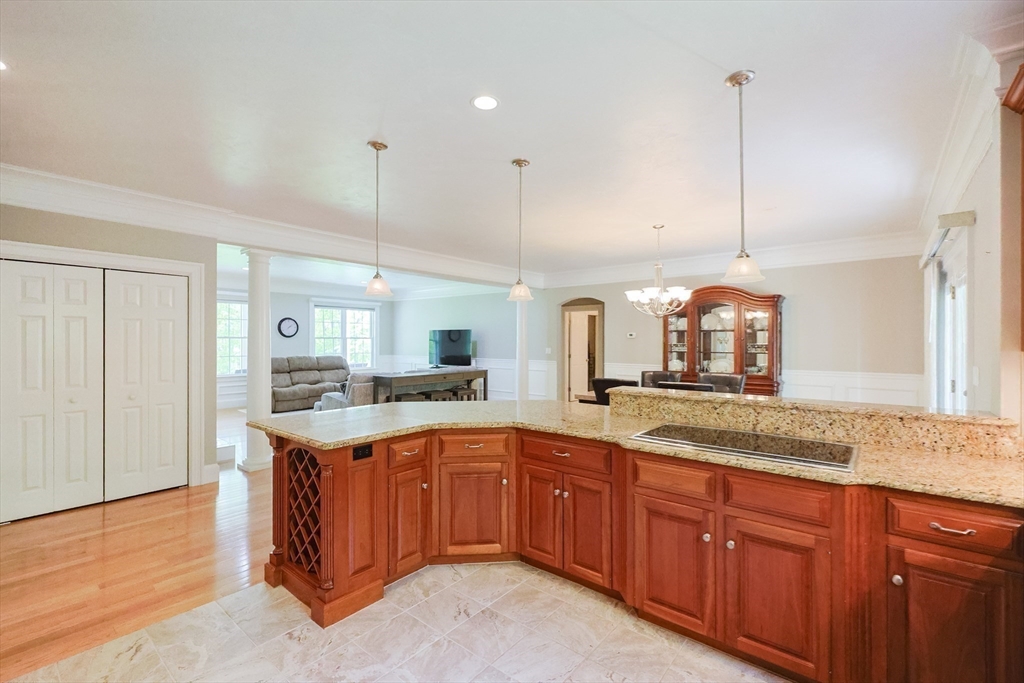 2 Powers Road Mendon, MA 01756 - Photo 13 of 40 a kitchen with a sink stove and wooden cabinets