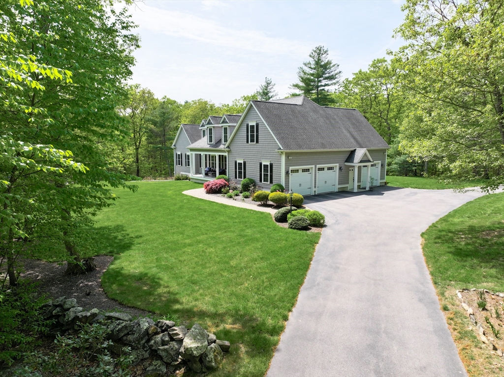 2 Powers Road Mendon, MA 01756 - Photo 2 of 40 a front view of a house with a garden and trees