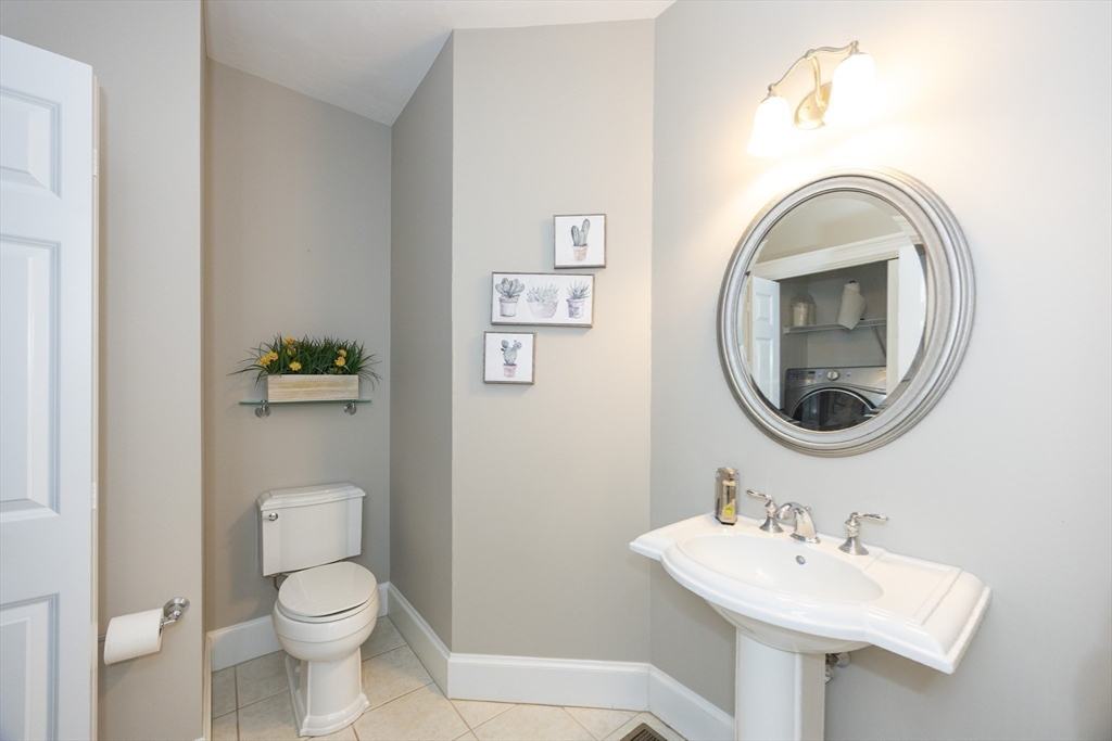 2 Powers Road Mendon, MA 01756 - Photo 26 of 40 a bathroom with a toilet a sink and mirror