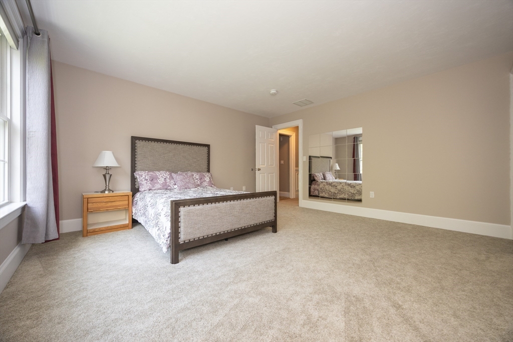 2 Powers Road Mendon, MA 01756 - Photo 27 of 40 a bedroom with a bed couch and window