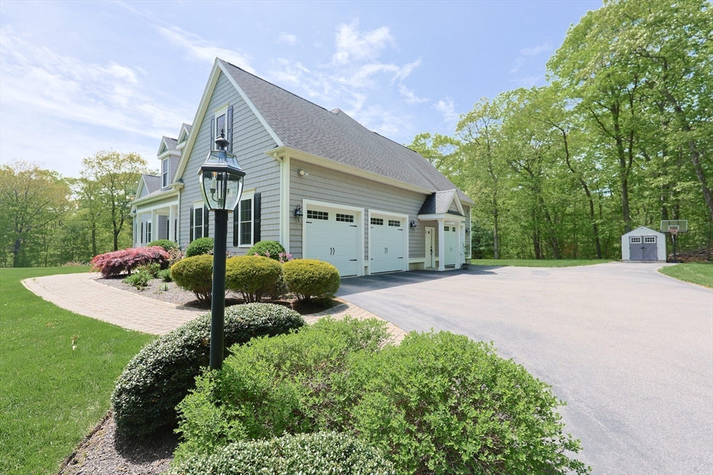 2 Powers Road Mendon, MA 01756 - Photo 3 of 40 a front view of a house with a yard and garage