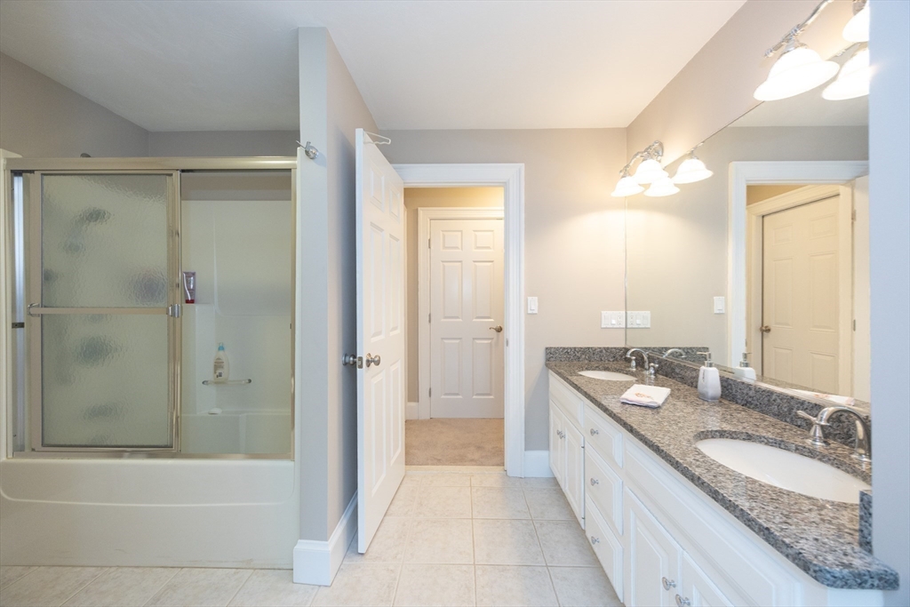 2 Powers Road Mendon, MA 01756 - Photo 33 of 40 a bathroom with a granite countertop tub a sink and a shower