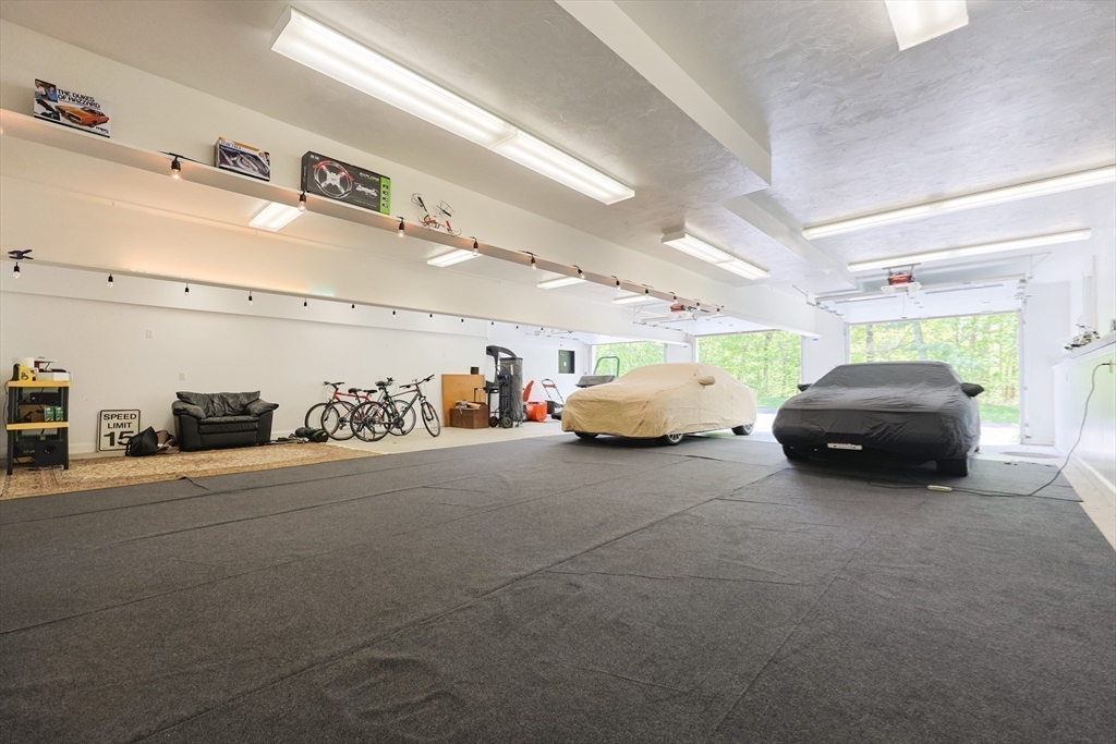 2 Powers Road Mendon, MA 01756 - Photo 35 of 40 a garage with a car furniture and tools shelf