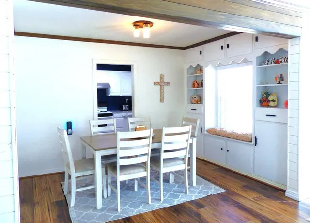 a dining room with furniture and wooden floor