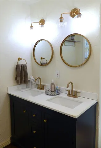 a bathroom with a double vanity sink and a mirror