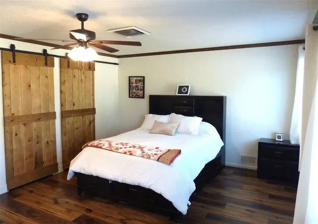 a bedroom with a bed and a chandelier