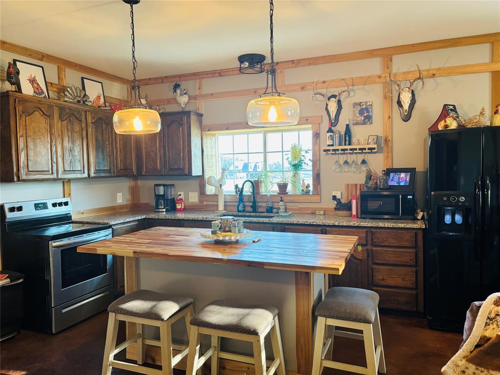 1883 Jc Maples Road Gunter, TX 75058 - Photo 10 of 12 a kitchen with a sink cabinets and window