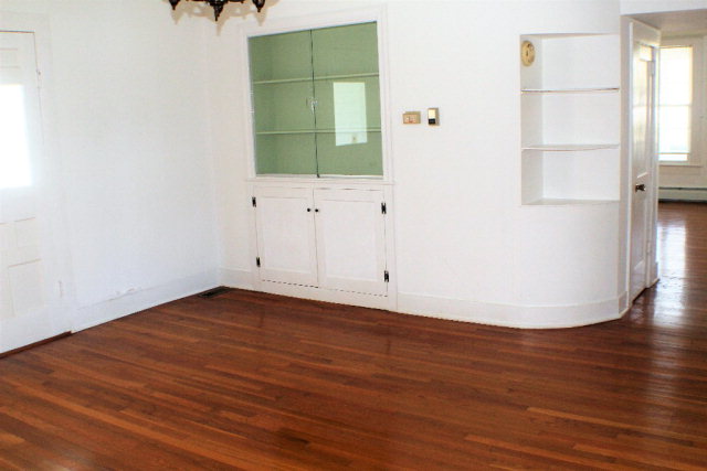 9593 Atlantic Road Atlantic, VA 23303 - Photo 6 of 20 an empty room with wooden floor and windows