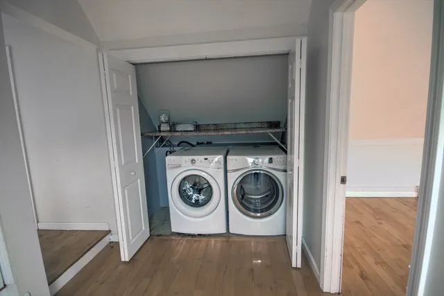 a view of a hallway with furniture and a window