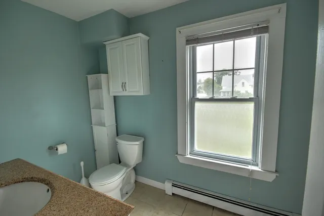 a view of house with backyard and garden