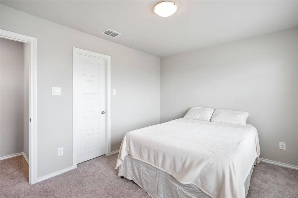 321 Pasture Drive Midlothian, TX 76065 - Photo 32 of 40 a bedroom with a bed and a night stand